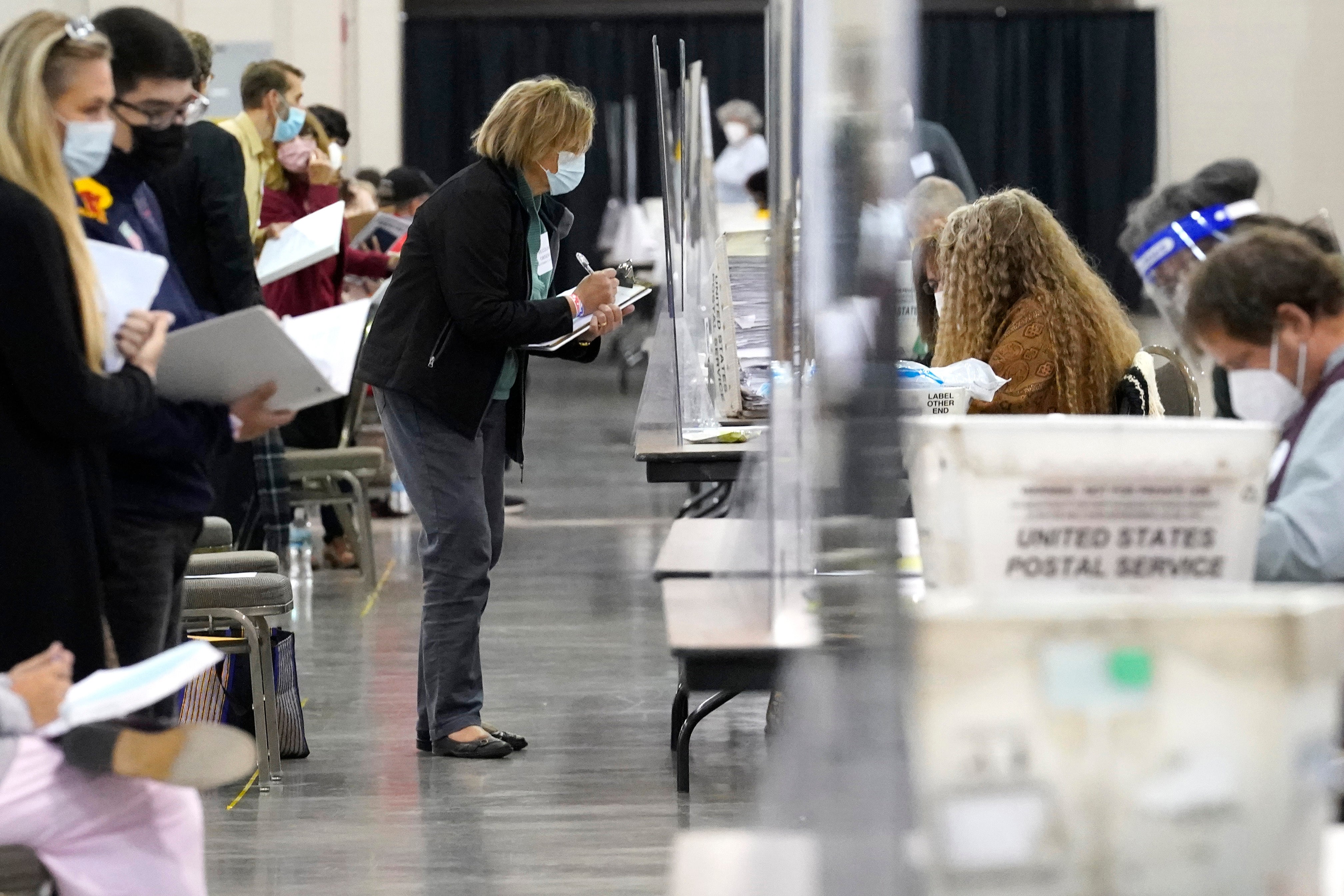 Recount observers observe ballots during a hand count of Milwaukee's presidential votes on November 20, 2020 at the Wisconsin Center in Milwaukee, Wisconsin. Counties across the country are rolling out new measures to promote transparency ahead of the 2024 presidential election